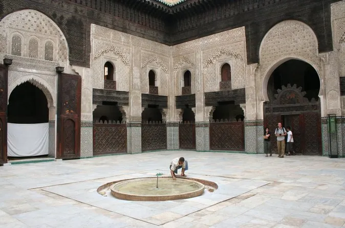 The carved courtyard of a medersa in Fes with a marble fountain
